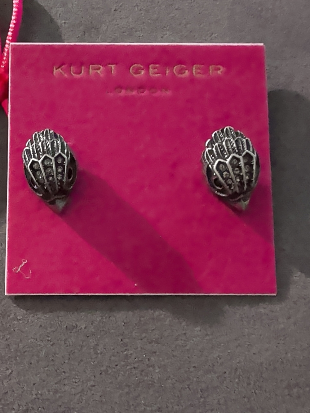 Kurt Geiger Silver Shell Motif Stud Earrings on Pink Card